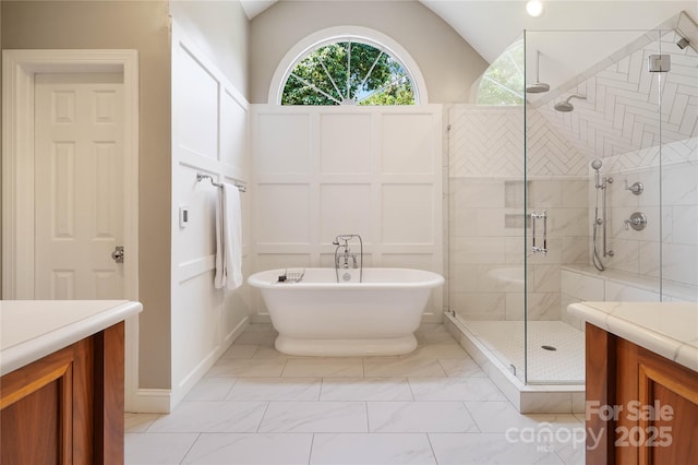 19946 River Falls Dr, Davidson, NC 28036 - full bath featuring a stall shower, vanity, a freestanding bath, lofted ceiling, and marble finish flooring