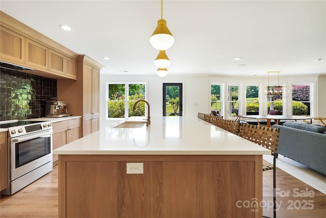 19946 River Falls Dr, Davidson, NC 28036 - kitchen featuring stainless steel electric range oven, a sink, light countertops, a kitchen bar, and recessed lighting