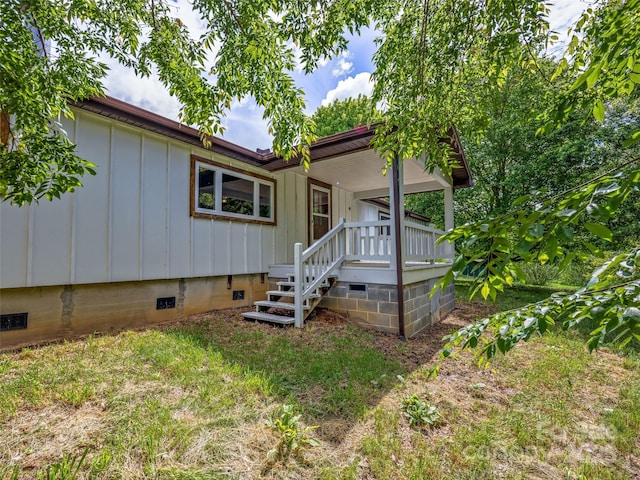 74 Saturn Ct, Clyde, NC 28721 - view of front facade featuring board and batten siding and crawl space