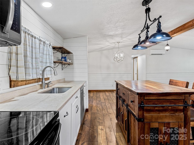 74 Saturn Ct, Clyde, NC 28721 - kitchen featuring a sink, stainless steel appliances, a wall mounted air conditioner, wood counters, and wooden walls