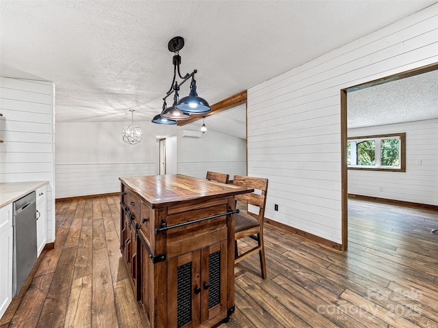 74 Saturn Ct, Clyde, NC 28721 - dining room with wood walls, dark wood-style flooring, a textured ceiling, a chandelier, and baseboards