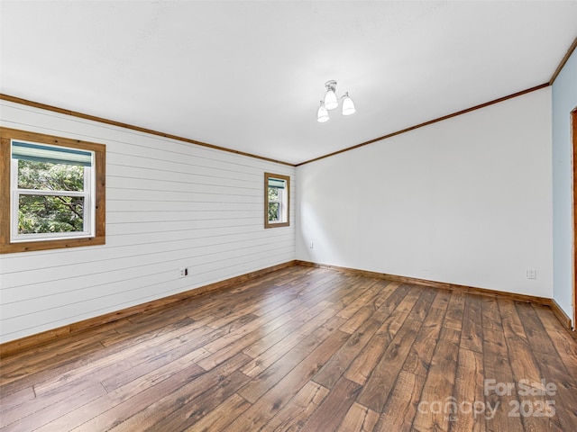 74 Saturn Ct, Clyde, NC 28721 - empty room featuring hardwood / wood-style flooring, ornamental molding, baseboards, and wood walls