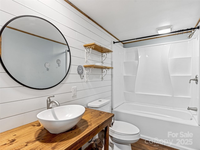 74 Saturn Ct, Clyde, NC 28721 - full bath with bathing tub / shower combination, toilet, wood finished floors, vanity, and wood walls