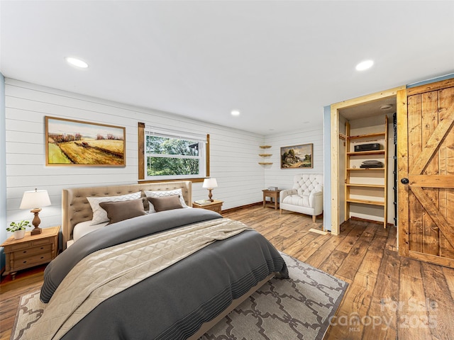 74 Saturn Ct, Clyde, NC 28721 - bedroom featuring hardwood / wood-style floors, wood walls, and recessed lighting