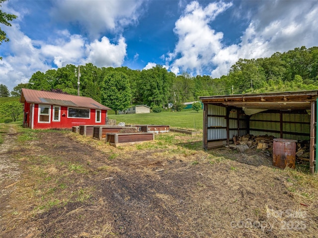 74 Saturn Ct, Clyde, NC 28721 - view of yard with an outbuilding, an outdoor structure, and a wooded view