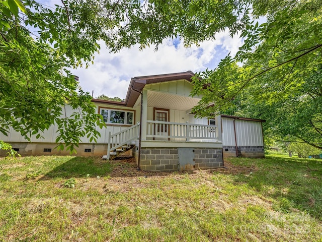 74 Saturn Ct, Clyde, NC 28721 - rear view of property featuring crawl space, board and batten siding, a yard, and stairway