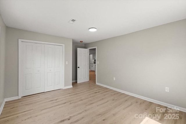 1746 2nd Street Pl SW, Hickory, NC 28602 - unfurnished bedroom with light wood-style flooring, baseboards, and a closet