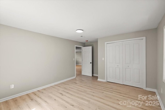 1746 2nd Street Pl SW, Hickory, NC 28602 - unfurnished bedroom featuring wood finished floors, baseboards, and a closet