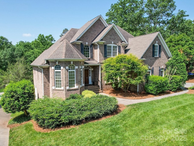 1508 Avalon Oaks Ct, Dallas, NC 28034 - traditional home with brick siding, a front lawn, and a shingled roof