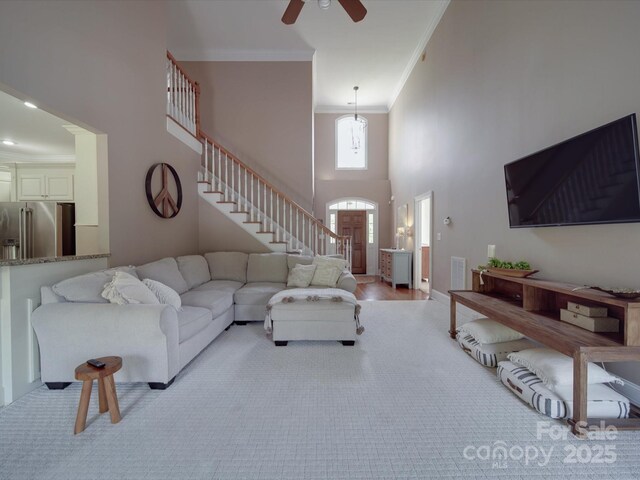 1508 Avalon Oaks Ct, Dallas, NC 28034 - living area with ornamental molding, stairway, a ceiling fan, a high ceiling, and light carpet