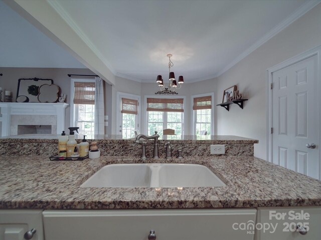 1508 Avalon Oaks Ct, Dallas, NC 28034 - kitchen featuring a sink, light stone counters, white cabinets, a chandelier, and ornamental molding