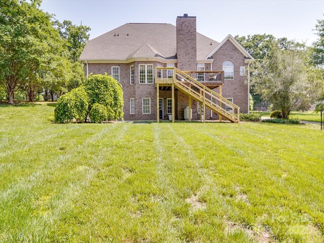 1508 Avalon Oaks Ct, Dallas, NC 28034 - rear view of house with stairs, brick siding, a deck, a chimney, and a yard