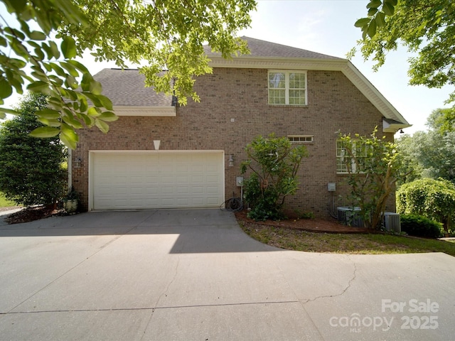 1508 Avalon Oaks Ct, Dallas, NC 28034 - view of front of property featuring driveway, a garage, brick siding, central AC unit, and a shingled roof