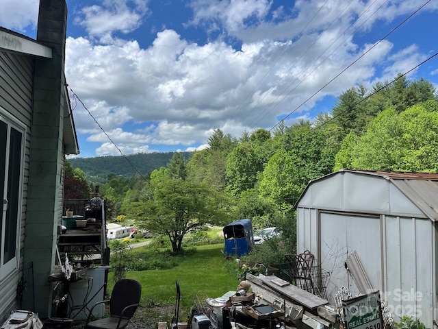 125 Parker Cove Rd, Weaverville, NC 28787 - view of grassy yard with a shed, an outbuilding, and a wooded view
