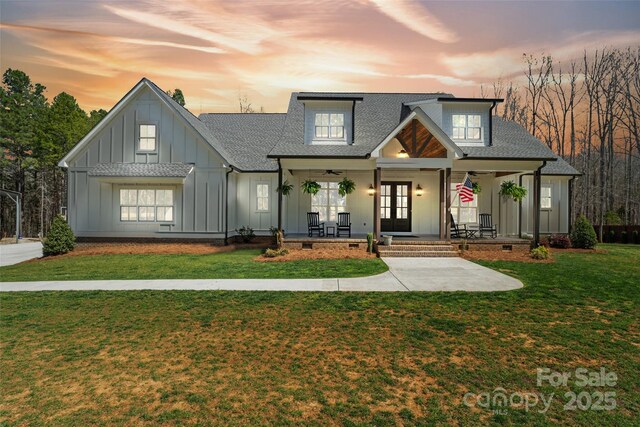 722 Clegg Farm Dr, York, SC 29745 - view of front of house featuring board and batten siding, a porch, french doors, a shingled roof, and a lawn