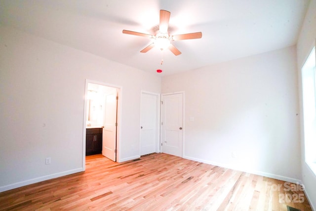 7 Berry Crest Ln, Arden, NC 28704 - unfurnished bedroom featuring light wood-style flooring, ensuite bathroom, baseboards, and ceiling fan