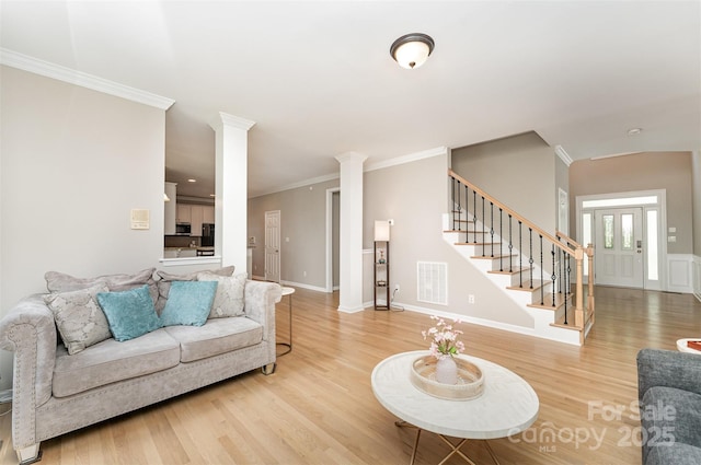1147 Anduin Falls Dr, Charlotte, NC 28269 - living room featuring light wood finished floors, stairway, decorative columns, ornamental molding, and baseboards