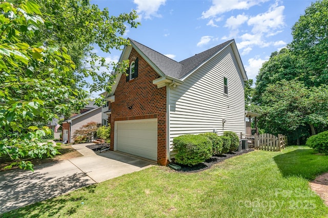 1147 Anduin Falls Dr, Charlotte, NC 28269 - view of side of home with an attached garage, driveway, a shingled roof, and brick siding