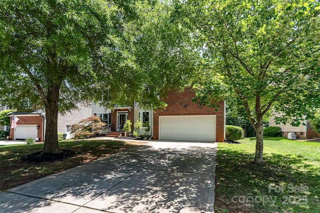 1147 Anduin Falls Dr, Charlotte, NC 28269 - view of property hidden behind natural elements with brick siding, driveway, and a front lawn