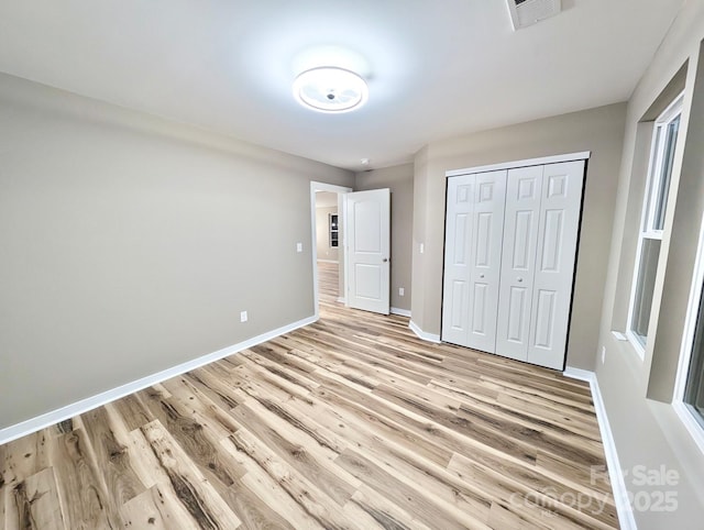 6756 Denver Heights Cir, Denver, NC 28037 - unfurnished bedroom with light wood finished floors, baseboards, and a closet