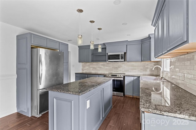 211 Ridgecrest St, Kannapolis, NC 28081 - kitchen featuring appliances with stainless steel finishes, a sink, wood finish floors, open shelves, and dark stone counters
