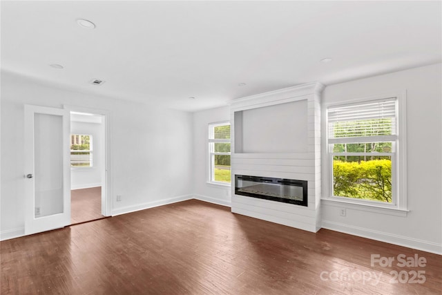 211 Ridgecrest St, Kannapolis, NC 28081 - unfurnished living room with a large fireplace, wood finished floors, baseboards, and healthy amount of natural light