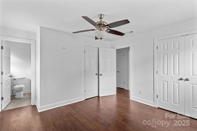 211 Ridgecrest St, Kannapolis, NC 28081 - unfurnished bedroom featuring baseboards, wood finished floors, ensuite bathroom, a ceiling fan, and a closet