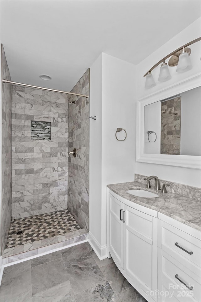 211 Ridgecrest St, Kannapolis, NC 28081 - bathroom featuring vanity, tiled shower, and baseboards