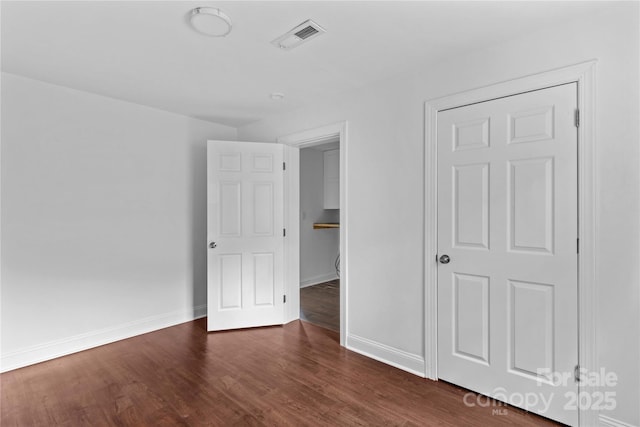 211 Ridgecrest St, Kannapolis, NC 28081 - unfurnished bedroom featuring dark wood finished floors and baseboards