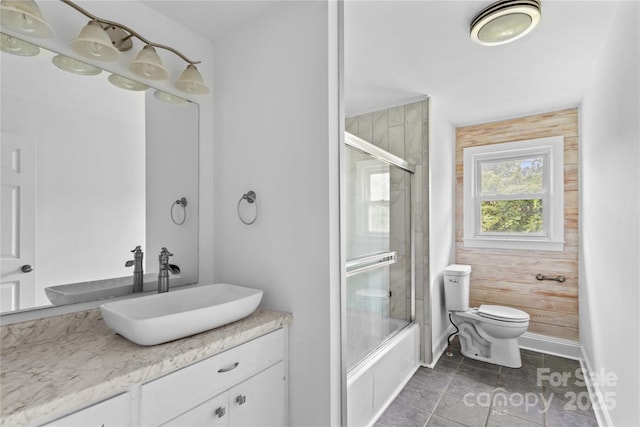 211 Ridgecrest St, Kannapolis, NC 28081 - bathroom with toilet, vanity, baseboards, shower / bath combination with glass door, and tile patterned floors