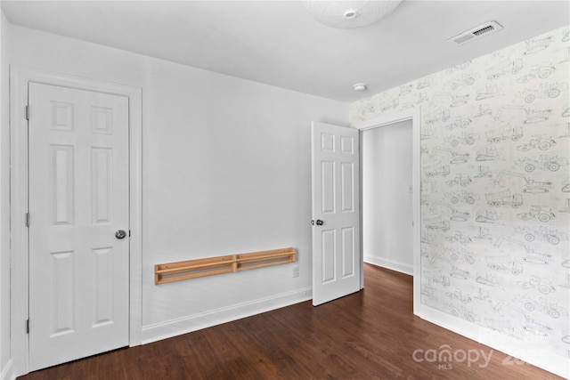 211 Ridgecrest St, Kannapolis, NC 28081 - empty room featuring wood finished floors, baseboards, and wallpapered walls