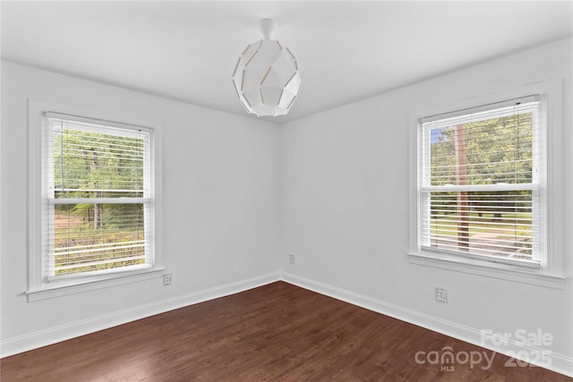 211 Ridgecrest St, Kannapolis, NC 28081 - unfurnished room featuring dark wood-style floors, healthy amount of natural light, and baseboards