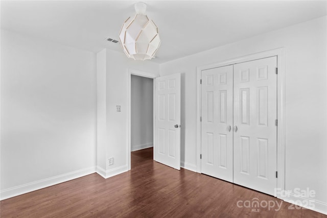211 Ridgecrest St, Kannapolis, NC 28081 - unfurnished bedroom featuring wood finished floors, baseboards, and a closet