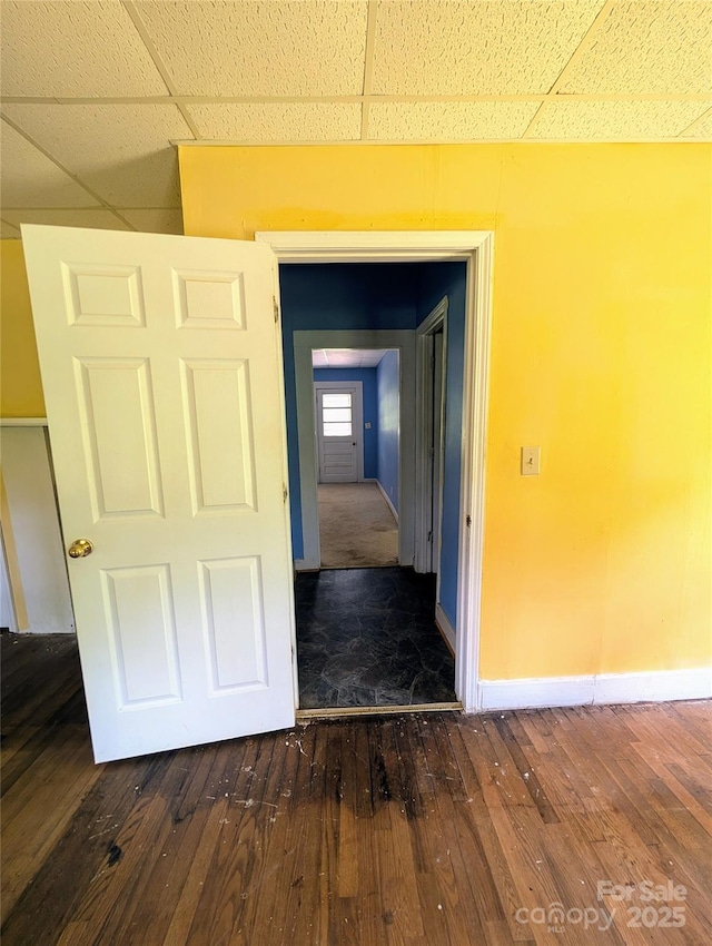 hall featuring hardwood / wood-style floors and baseboards