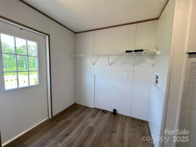 laundry room with wood finished floors, hookup for a washing machine, ornamental molding, and a heating unit