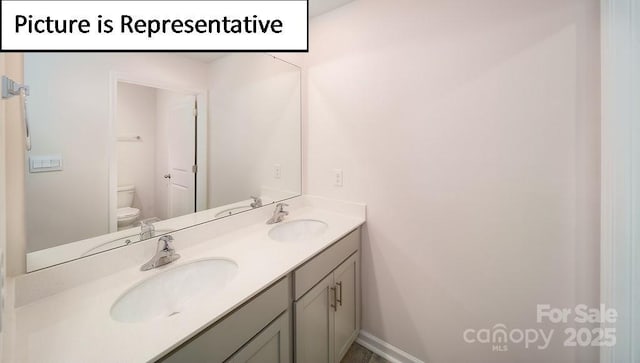 7729 Woolsey Dr, Gastonia, NC 28056 - bathroom featuring toilet, double vanity, and baseboards