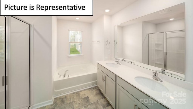 7729 Woolsey Dr, Gastonia, NC 28056 - full bathroom with a garden tub, a stall shower, double vanity, stone finish flooring, and recessed lighting