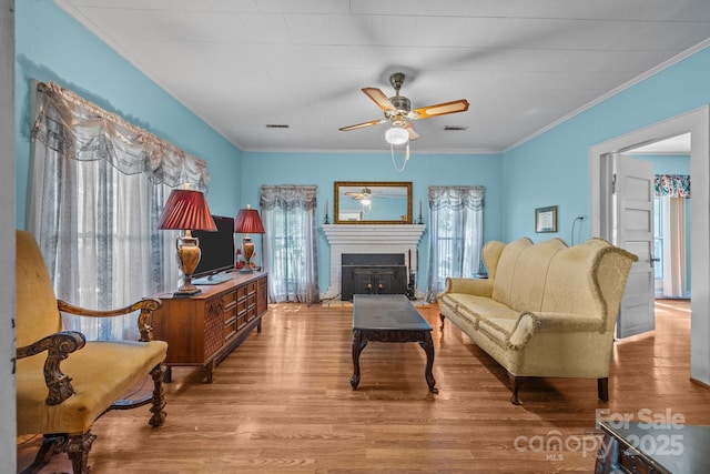 18070 Old Beatty Ford Rd, Gold Hill, NC 28071 - living room with ceiling fan, ornamental molding, wood finished floors, and a fireplace