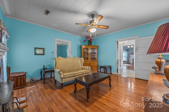 18070 Old Beatty Ford Rd, Gold Hill, NC 28071 - living room with ceiling fan, wood finished floors, crown molding, baseboards, and a fireplace