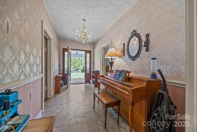 18070 Old Beatty Ford Rd, Gold Hill, NC 28071 - foyer entrance with wallpapered walls, a chandelier, wainscoting, and ornamental molding