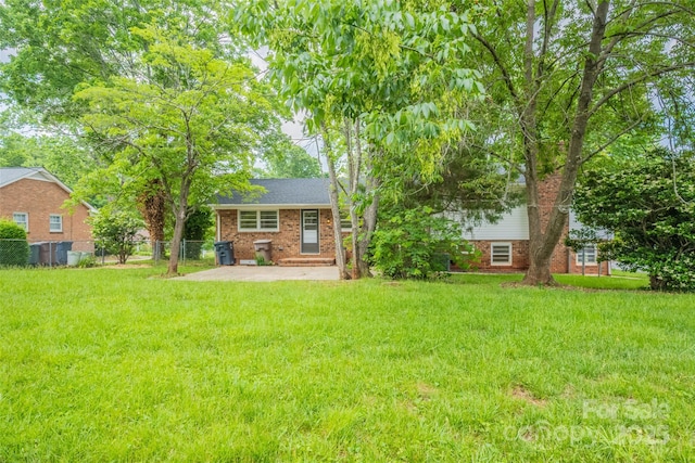 rear view of house featuring a patio and brick siding