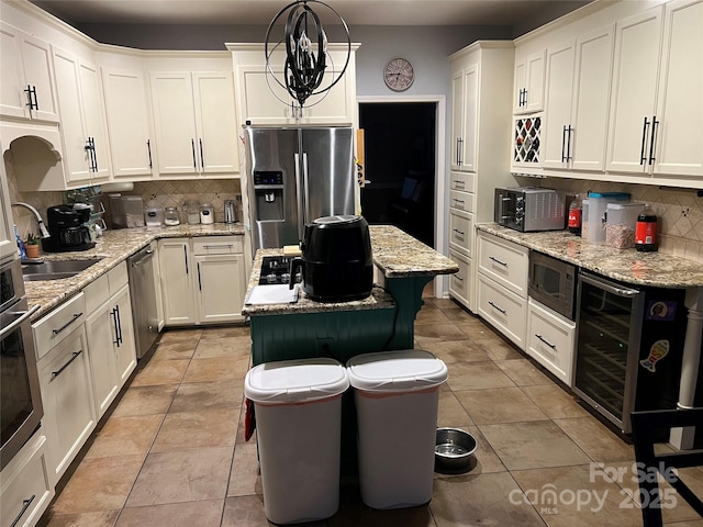 208 Stone Ridge Dr, Salisbury, NC 28146 - kitchen with a sink, stainless steel appliances, wine cooler, and decorative backsplash