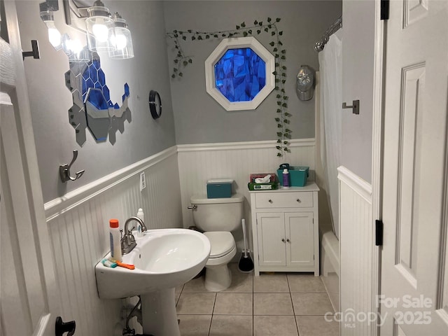 208 Stone Ridge Dr, Salisbury, NC 28146 - full bath with tile patterned floors, toilet, a wainscoted wall, and shower / tub combo
