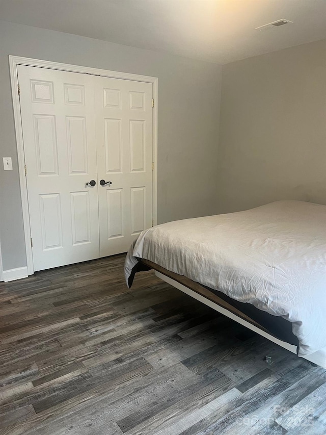 208 Stone Ridge Dr, Salisbury, NC 28146 - bedroom featuring dark wood-style flooring, a closet, and baseboards