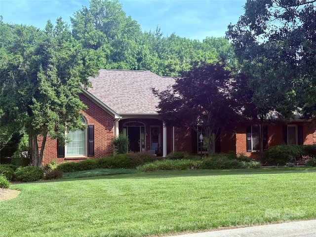 208 Stone Ridge Dr, Salisbury, NC 28146 - view of front of house with brick siding, a front yard, and a shingled roof