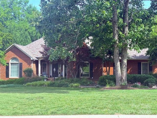208 Stone Ridge Dr, Salisbury, NC 28146 - view of property hidden behind natural elements featuring a front yard, brick siding, and a shingled roof