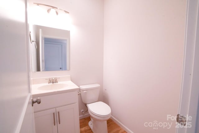 11 Berry Crest Ln, Arden, NC 28704 - bathroom with vanity, toilet, wood finished floors, and baseboards