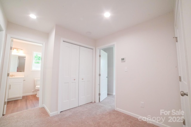 11 Berry Crest Ln, Arden, NC 28704 - unfurnished bedroom featuring light carpet, baseboards, a closet, ensuite bathroom, and recessed lighting