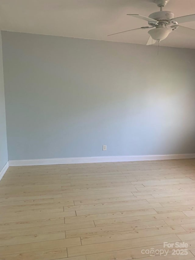 empty room featuring ceiling fan, light wood-style floors, and baseboards