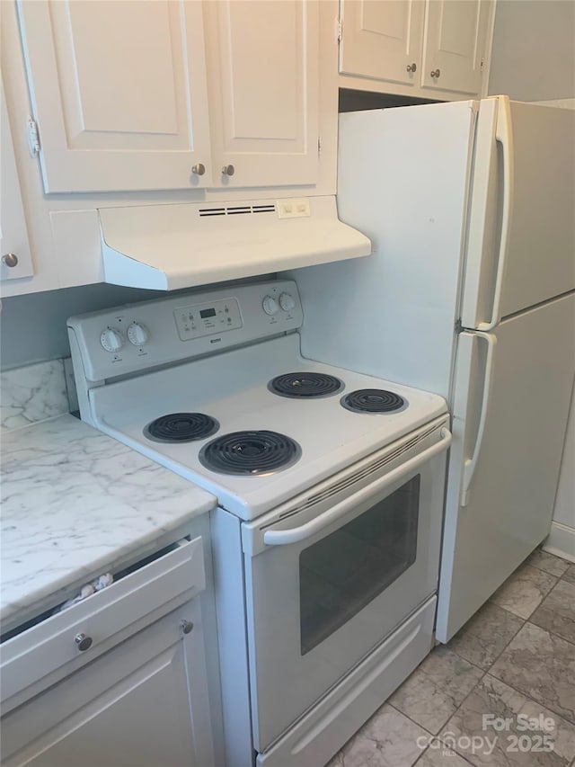 kitchen featuring white appliances, exhaust hood, light marble finish flooring, and light countertops